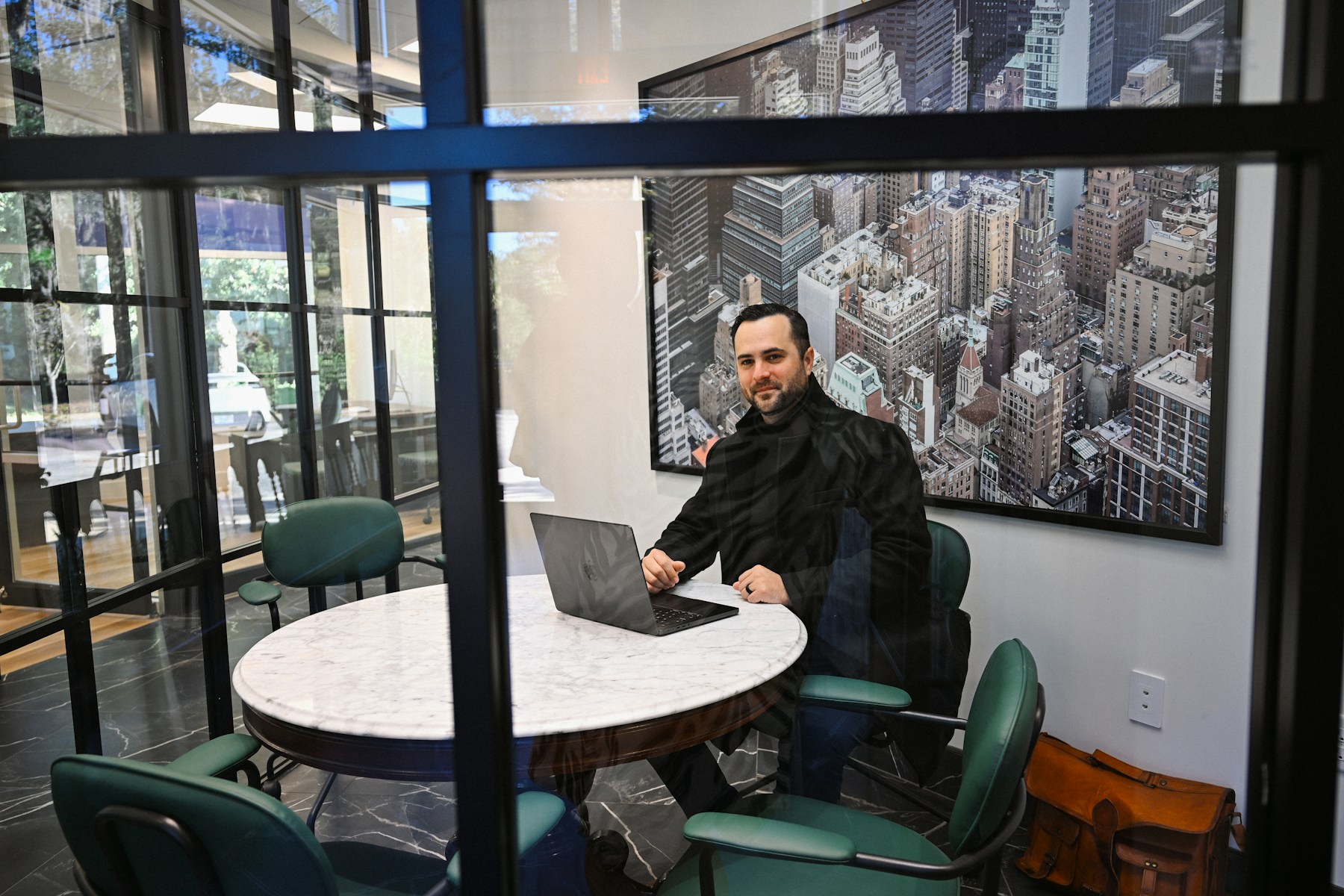 Consultant working at a laptop in an office